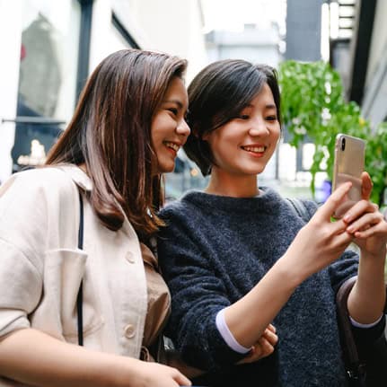 two women looking at phone